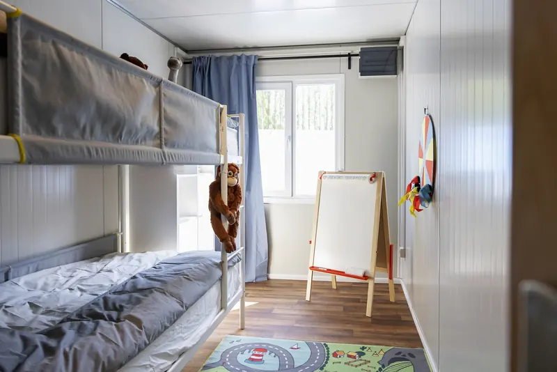 Kinderkamer met stapelbed, speelmat en tekenbord